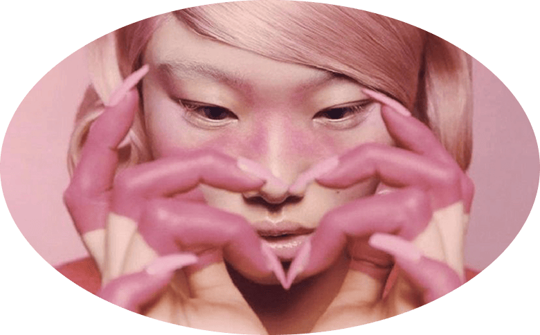 Pink Polish owner making a heart with manicured hands