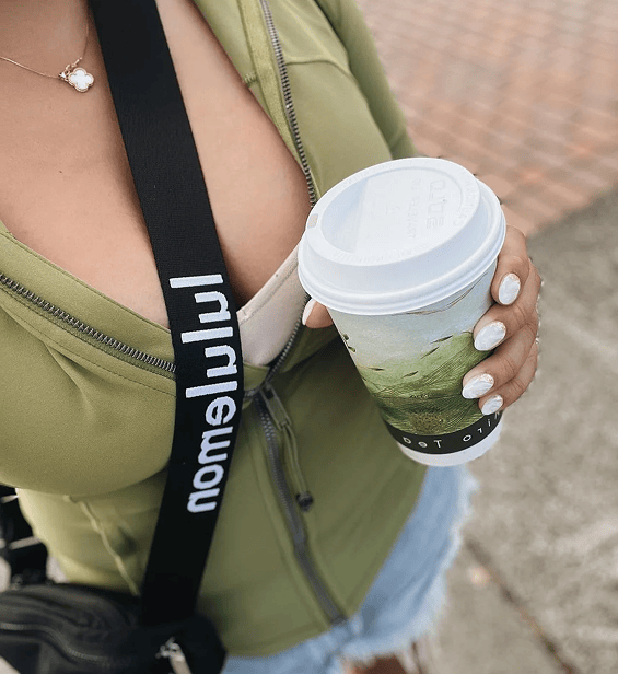 Customer holding a drink showing manicure